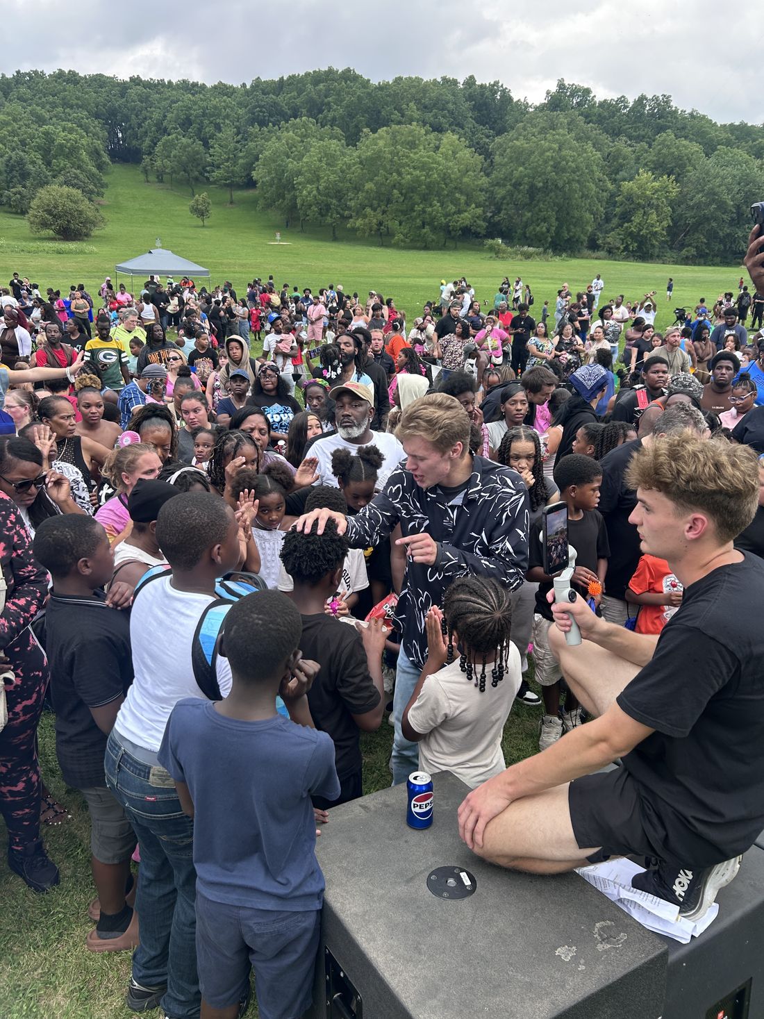 Ministers praying with people in the middle of a huge crowd at Madison Blessing Day