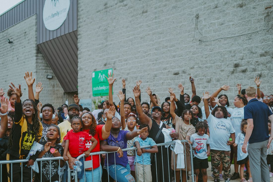 A crowd raising their hands toward the stage at the Saint Louis Giveback Festival